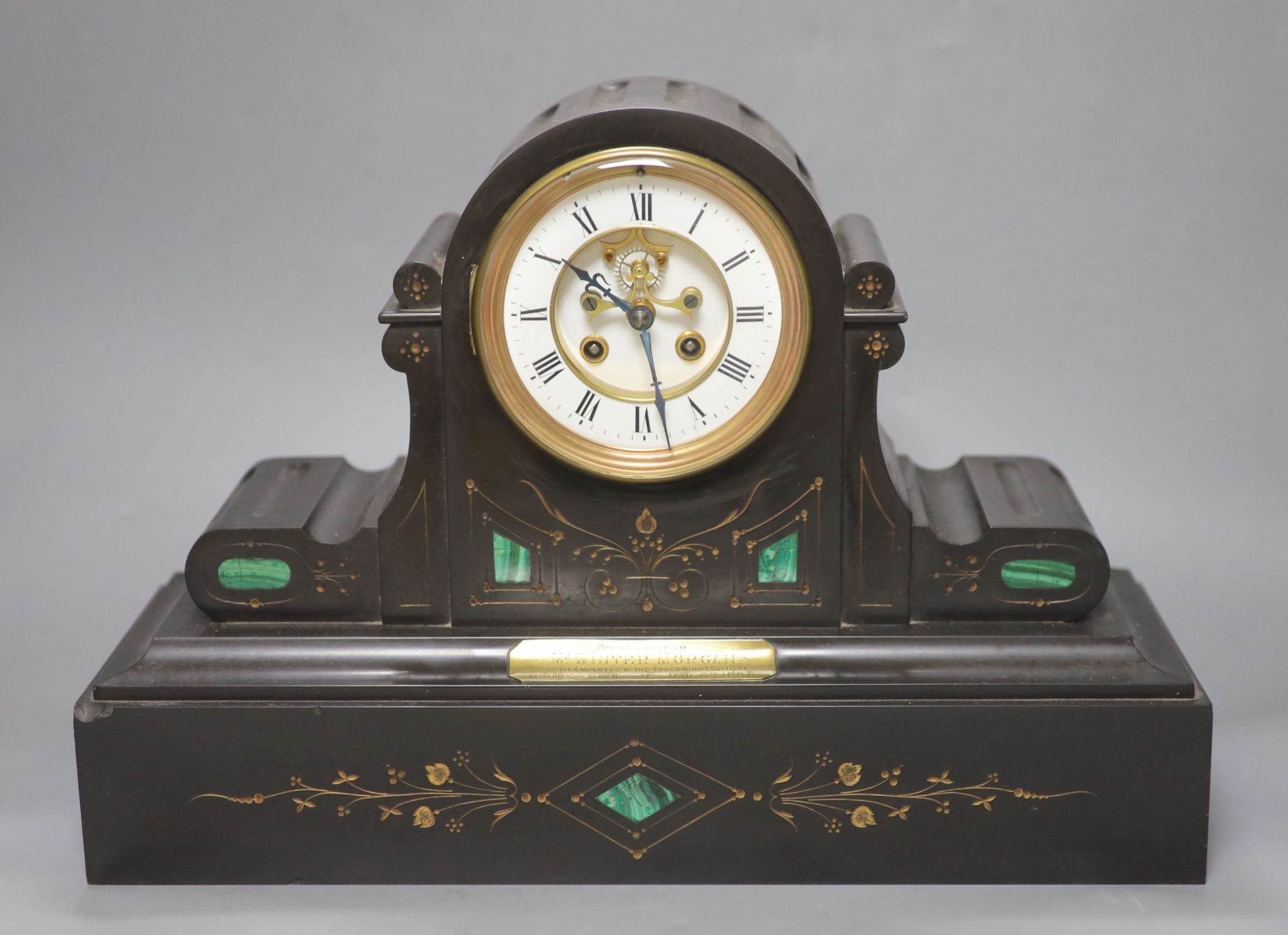 A Victorian black marble and inlaid malachite eight day mantel clock, plaque reads Presented to Mr Wintermorgan by the employees of